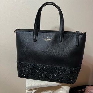 Small Kate Spade black with a glitter bottom bag.